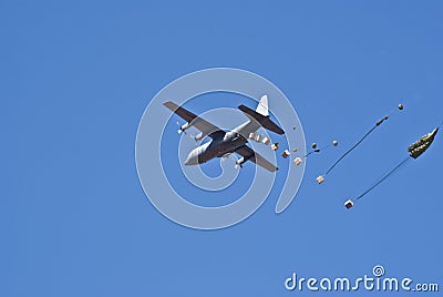 Cargo plane dropping supplies Stock Photo