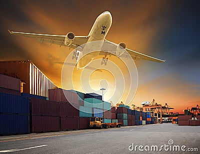 Cargo plane flying above container dock and ship port use for tr Stock Photo