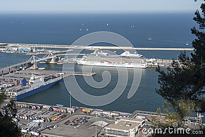 A cargo port with colorful containers and a large white ship Editorial Stock Photo