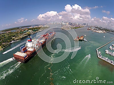 Cargo ship enters port aerial view Stock Photo