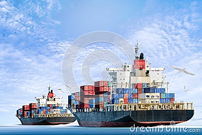 Cargo ship in the ocean with Birds flying in blue sky Stock Photo