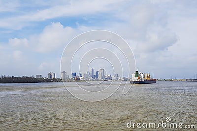 Cargo ship on a river and New Orleans city in background Stock Photo