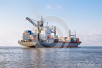 Cargo ship is sailing to sea to transport cargo in containers.Logistics and transportation of International Stock Photo