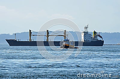 Cargo Ship and Tug Boat Stock Photo