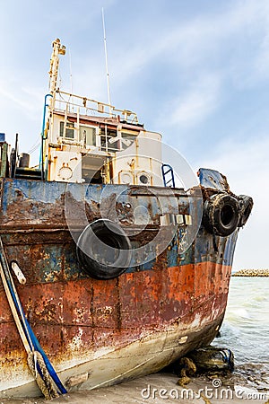 Cargo ship wreck washed ashore on the Al Hamriyah beach in Umm Al Quwain, United Arab Emirates Stock Photo