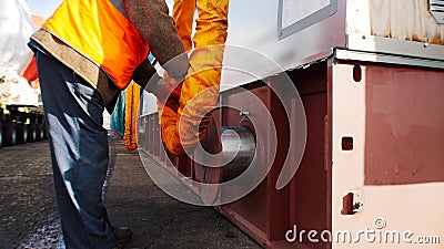 Cargo shipping - man worker fixing the flexible tube Stock Photo