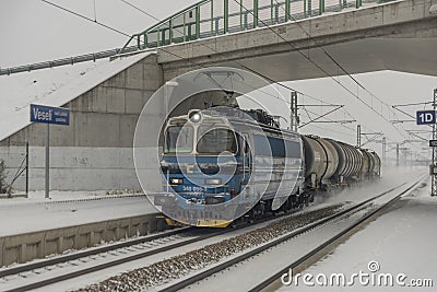 Cargo train near railway stop with snowy bridge 12 16 2022 Veseli nad Luznici CZ Editorial Stock Photo