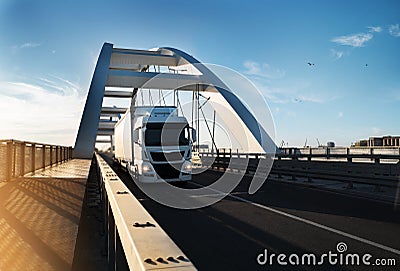 Cargo truck with trailer crossing modern bridge Stock Photo