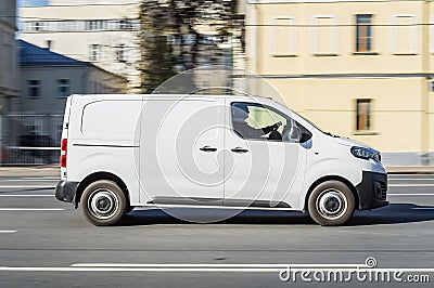 Cargo van Peugeot Expert driving in the city street. White minivan in motion, side view Editorial Stock Photo