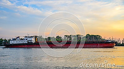 Big ship on the Danube river, big industrial vessel at the border with Ukraine a sunset Editorial Stock Photo