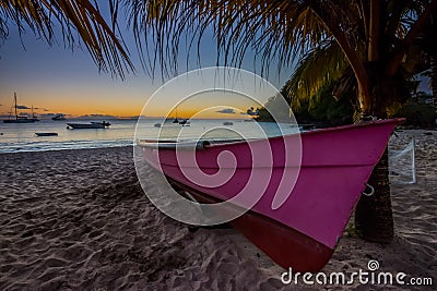 Caribbean Martinique beach sunset beside traditional fishing boat Stock Photo