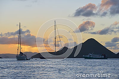 Caribbean sunset with sailboats and ferry at Soper`s Hole, West End, Tortola, BVI Editorial Stock Photo