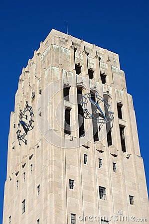 Carillon bell tower with clock against blue sky Stock Photo