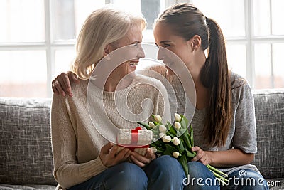 Caring adult daughter greet mother with anniversary Stock Photo