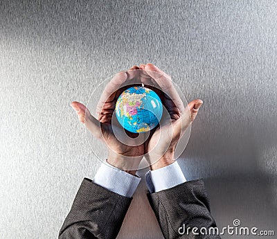 Caring businessman protecting the future of planet for environment health Stock Photo