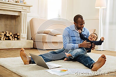 Caring father amusing his little son Stock Photo