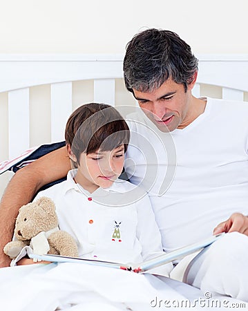 Caring father reading with his son Stock Photo