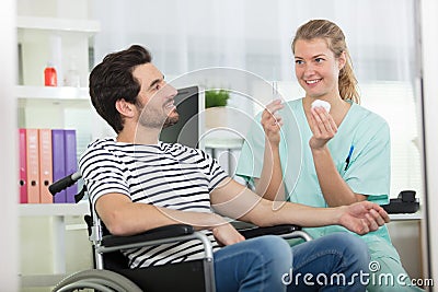 caring female nurse talking to disabled patient Stock Photo