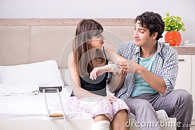The caring husband looking after his injured wife Stock Photo