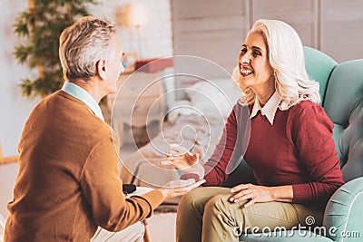 Caring husband presenting ring to his smiling wife Stock Photo