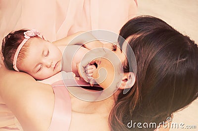 Caring mother holding with love her little cute sleeping baby gi Stock Photo