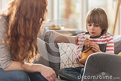 Caring mother supporting sick son Stock Photo