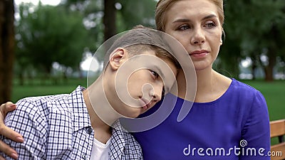 Caring mother supporting teen boy in time of trouble, bullying problem in school Stock Photo