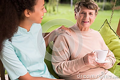 Caring nurse and elder woman Stock Photo