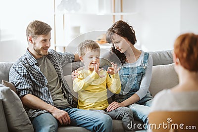 Parents and misbehaving boy during therapy session with counselor Stock Photo