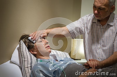 Caring senior man helping his sick wife Stock Photo