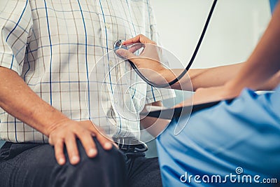 Caring young female doctor examining her contented senior patient. Stock Photo