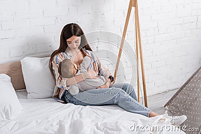 caring young mother holding in arms Stock Photo