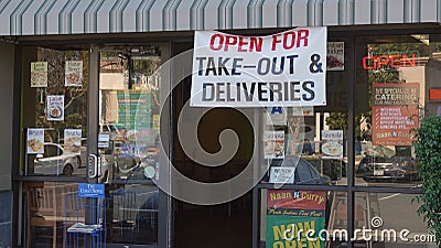 Carlsbad, CA / USA - May 11, 2020: Small restaurants advertise that they are still open for take-out and delivery with large signs Editorial Stock Photo