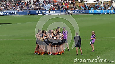 Carlton players together in a huddle before starting a game against Melbourne at Ikon Park Stadium Editorial Stock Photo