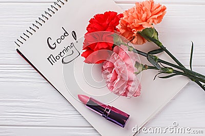 Carnation flowers, good morning wish and lipstic. Stock Photo