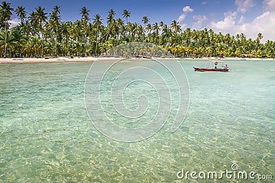 Carneiros idyllic beach with rustic boat at sunny day, in Northeastern Brazil Stock Photo