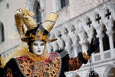 Carnival black-gold mask and costume at the traditional festival in Venice, Italy Editorial Stock Photo