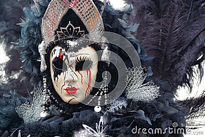 Carnival black-silver mask and costume at the traditional festival in Venice, Italy Editorial Stock Photo