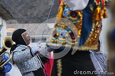 festival of the Virgen del Carmen in the town of Paucartambo celebrating singing, dancing with masks with grotesque Editorial Stock Photo