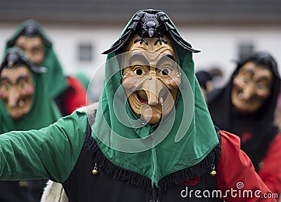 Carnival goer in a carved wooden mask Editorial Stock Photo