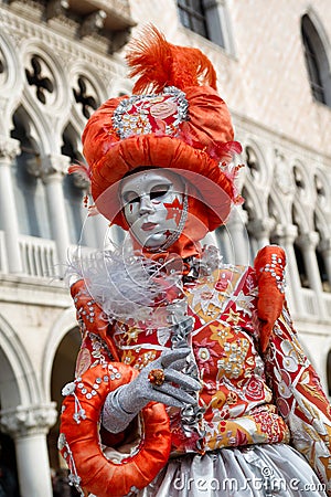 Carnival orange-silver mask and costume at the traditional festival in Venice, Italy Editorial Stock Photo