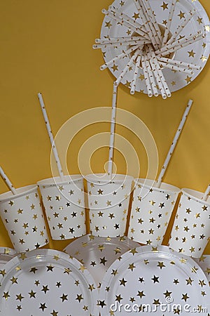 Carnival, paper holiday utensils with gold stars, yellow background and holiday eco-friendly utensils paper for przdel Stock Photo