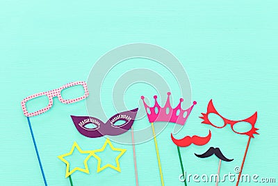 carnival party celebration concept with paper photo booth props over yellow background. Top view. Flat lay. Stock Photo