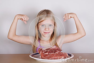 Carnivore keto diet concept - little blond girl eating raw meat Stock Photo