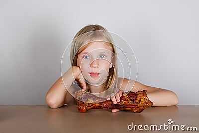 Carnivore keto diet concept - little blond girl eating raw meat Stock Photo