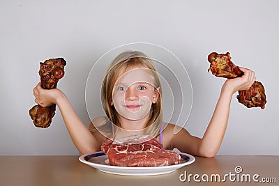 Carnivore keto diet concept - little blond girl eating raw meat Stock Photo