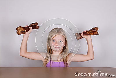 Carnivore keto diet concept - little blond girl eating raw meat Stock Photo