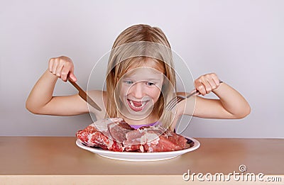 Carnivore keto diet concept - little blond girl eating raw meat Stock Photo