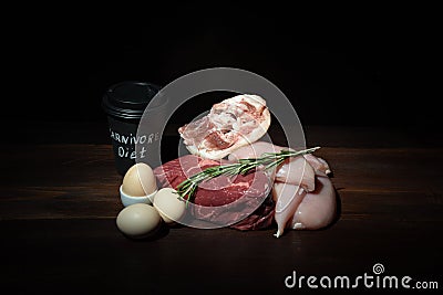 Carnivore keto diet. coffee eggs, beef steak, chicken breast and pork shank assorted meat near a board made of natural Stock Photo