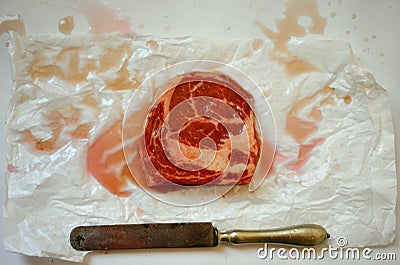 Carnivore, meat diet conceptual image with rib eye steak ready to be cooked on a white background Stock Photo